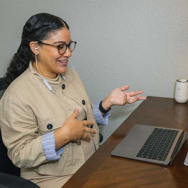 Woman with headphones on video call