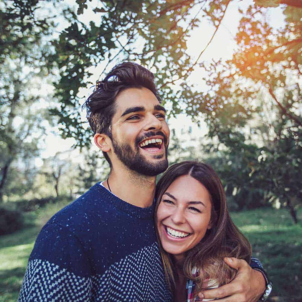 Happy smiling couple embracing outdoors