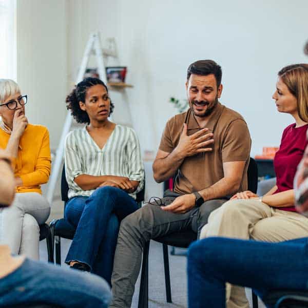 Man talking in a group setting